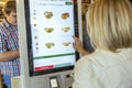 Moscow, Russia, 08/11/2019: A woman chooses food at McDonald`s in the electronic menu