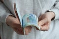 Moscow, Russia, 03/27/2022, a woman counts banknotes with her hands. European money, euro.