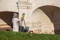 A woman painting a picture in the open air. Hobby in the park.