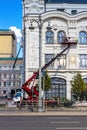 Workers in the cradle of a crane, restoring the facade of the building Royalty Free Stock Photo