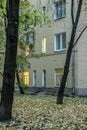 Yard view of wall and lighting windows of residential building tonight.