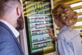 Moscow, Russia, 08/02/2019: Young beautiful woman in McDonald`s chooses food on an electronic board