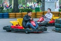 Young guys having fun in the park. Men karting close up.