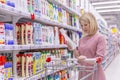 Moscow, Russia, 07.24.2019: A young woman in the department of household chemicals in a supermarket selects a product Royalty Free Stock Photo