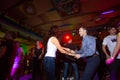 MOSCOW, RUSSIAN FEDERATION - OCTOBER 13, 2018: A middle-aged couple, a man and a woman, dance salsa among a crowd of dancing peopl Royalty Free Stock Photo