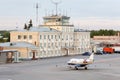 Small airliner stands near building Royalty Free Stock Photo