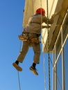 Alpinist worker doing high altitude job