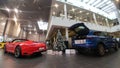 Moscow. Winter 2019. New year in Porsche Center. 911 Carrera and Macan near christmas tree. Presents in the trunk Royalty Free Stock Photo