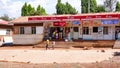 Country store with young kids walking by in front in rural Tanzania near Moshi