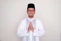 Moslem Asian man smiling at the camera with hand praying pose Royalty Free Stock Photo