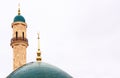 Mosque with beautiful green domes and minaret.