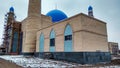 A mosque is being built in the clear sky