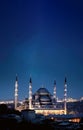 A mosque in the city at dusk, with a beautiful blue sky dome as the building exterior. Royalty Free Stock Photo