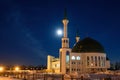 Mosque with a dome and a minaret against the background of the night sky. Royalty Free Stock Photo