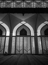 Mosque door with a person reciting the Koran.