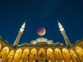 Mosque and eclipsed moon at night. Ramadan or islamic concept image Royalty Free Stock Photo