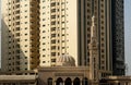Mosque in front of tall high-risings Royalty Free Stock Photo