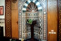 A mosque from inside with Islamic decorative style, mosque Mihrab or niche with a Quran put on a wooden stand and a microphone