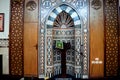 A mosque from inside with Islamic decorative style, mosque Mihrab or niche with a Quran put on a wooden stand