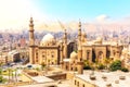 The Mosque-Madrassa of Sultan Hassan and the Pyramids on the background, beautiful view of Cairo, Egypt