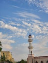 Mosque minare with scattered clouds sky, Oman