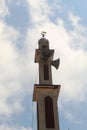 a mosque minaret against a background of blue sky and bright white clouds Royalty Free Stock Photo