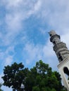 Mosque minaret against blue sky background Royalty Free Stock Photo