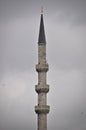 Mosque minaret and gray clouds Royalty Free Stock Photo