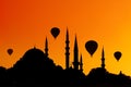 Mosque minarets and hot air balloons at sunset. Istanbul. Turkey.