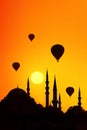 Mosque minarets and hot air balloons at sunset. Istanbul. Turkey.