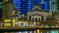 Mosque among modern high rise buildings, towers and hotels timelapse at Dubai Marina, United Arab Emirates, Middle East Royalty Free Stock Photo