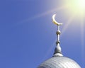 Mosque of Muslim. Crescent on copper covered dome and minaret of mosque against blue sky. Symbol of Islam and Ramadan