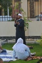 A mosque preacher Imam performs Eid Al Adha Khutbah (sermon) in an open air space near the mosque,