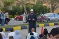 A mosque preacher Imam performs Eid Al Fetr Khutbah (sermon) in an open air space near the mosque,