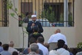 A mosque preacher Imam performs Eid Al Fitr Khutbah (sermon) in an open air space