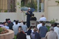 A mosque preacher Imam performs Eid Al Fitr Khutbah (sermon) in an open air space