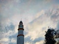 The mosque tower rises against the backdrop of a cloudy evening sky. Royalty Free Stock Photo