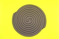 Mosquito coil insect repellent isolated on yellow background.