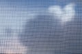 Mosquito net on a blue cloudy sky. Royalty Free Stock Photo
