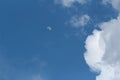 Blue sky with clouds. Spring or summer background. The moon is visible among the clouds. Royalty Free Stock Photo