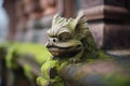moss-covered gargoyle on an ancient buildings corner Royalty Free Stock Photo