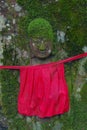 Moss covered jizo on tree Royalty Free Stock Photo