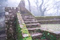 Moss covered old steps and stairs of the Moorish Castle Castle of Moors on a foggy, misty day in Sintra Portugal Royalty Free Stock Photo