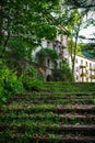 A moss-covered staircase leading to an old abandoned house. Ghost town miners coal Tkvarcheli. Abkhazia