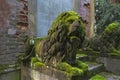 Moss-covered stone sculptures of lions.