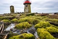 moss-covered stones at the base of an inland lighthouse