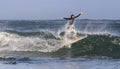 Mossel Bay, South Africa. Surfing the waves. Surfer riding wave, storm sky