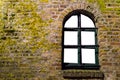 Mossy brick wall with a old wooden window frame, empty framework isolated on white Royalty Free Stock Photo