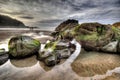 Mossy rocks at the beach in Deba, Spain Royalty Free Stock Photo