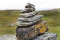 A mossy stacked rocks with green country field